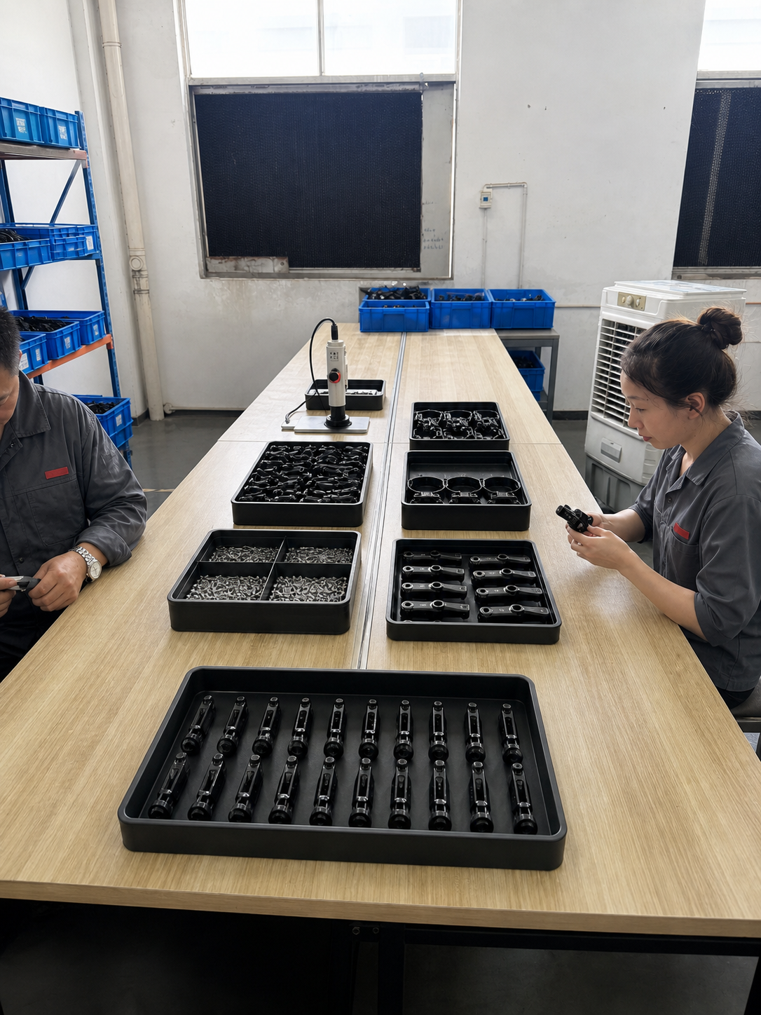 BENGGUO team performing final assembly at an organized workbench